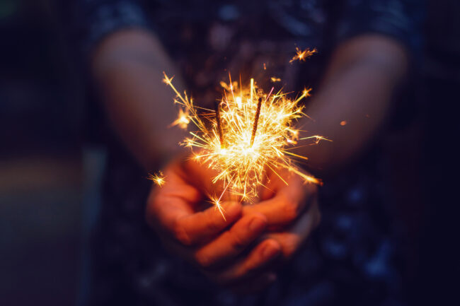 Christmas, New year sparkler in woman hands.